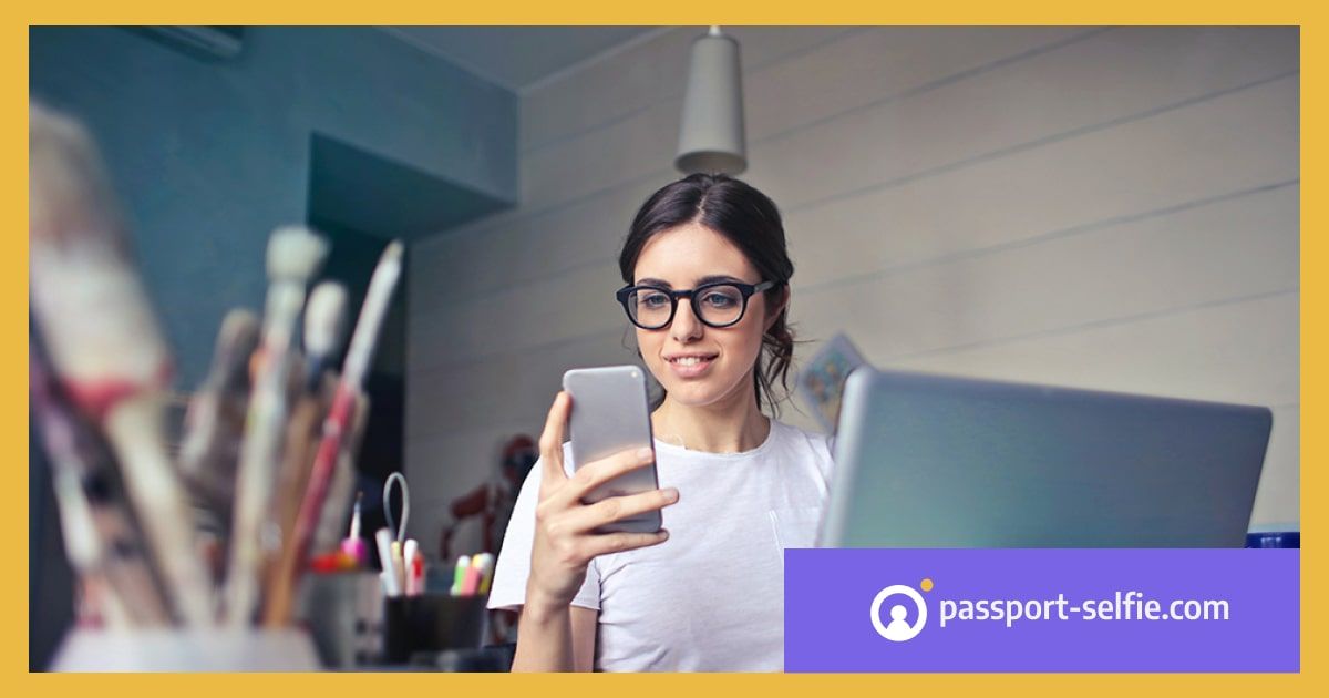 Eine Frau bearbeitet Fotos auf ihrem Handy in einem Studio